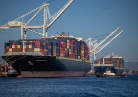 A cargo ship full of shipping containers is seen at the port of Oakland, California